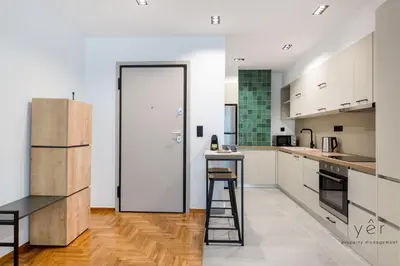 a kitchen with white cabinets and a ladder at Comfort Oasis: Work-Friendly Space w/Fiber Net in Athens