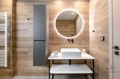 a bathroom with a sink and a mirror at Comfort Oasis: Work-Friendly Space w/Fiber Net in Athens