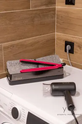 two pens and a hair dryer on top of a appliance at Comfort Oasis: Work-Friendly Space w/Fiber Net in Athens