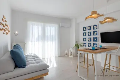 a living room with a couch and a table at Shell-Charm w/Sea View & Parking in Piraeus