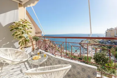 a balcony with a table and chairs and the ocean at Shell-Charm w/Sea View & Parking in Piraeus
