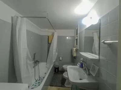 a small bathroom with a sink and a toilet at 3-Generations Athenian home in Athens