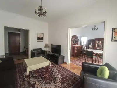 a living room with a couch and a table at 3-Generations Athenian home in Athens