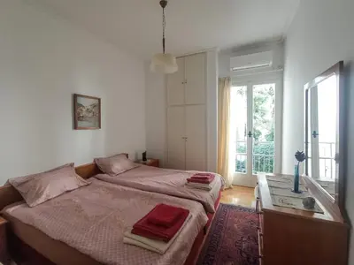 a bedroom with two beds and a window at 3-Generations Athenian home in Athens