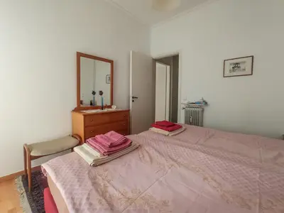 a bedroom with a bed with a dresser and a mirror at 3-Generations Athenian home in Athens