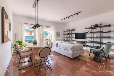 a living room with a couch and a table and chairs at Luxury Flat w/2Bath - Private Parking @Pasalimani in Piraeus