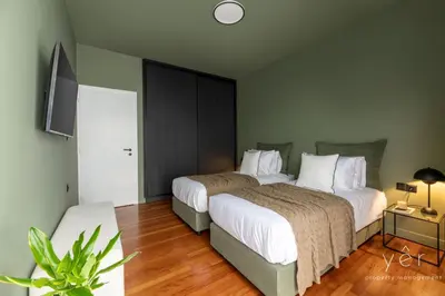 a hotel room with two beds and a tv at Luxury Flat w/2Bath - Private Parking @Pasalimani in Piraeus