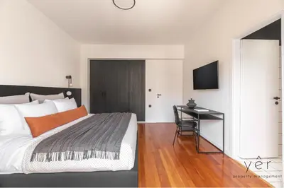 a bedroom with a bed and a desk in it at Luxury Flat w/2Bath - Private Parking @Pasalimani in Piraeus