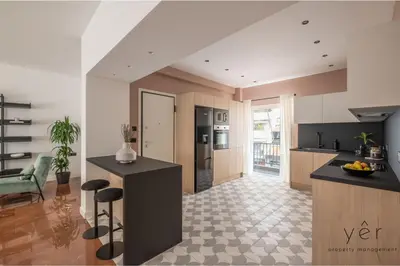 a kitchen with a black island in a room at Luxury Flat w/2Bath - Private Parking @Pasalimani in Piraeus