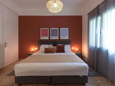 a bedroom with a large bed and two lamps at Stylish Sanctuary, Pangrati Gem Refurbished in Athens