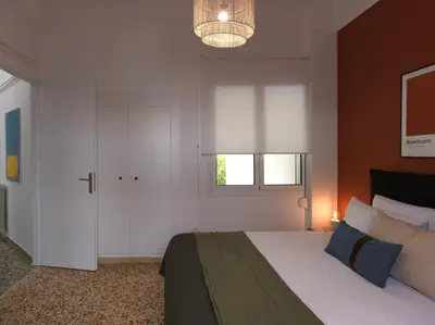 a bedroom with a large bed and a window at Stylish Sanctuary, Pangrati Gem Refurbished in Athens