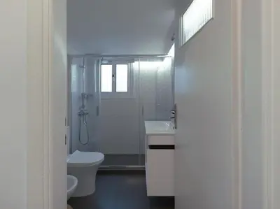 a white bathroom with a toilet and a sink at Stylish Sanctuary, Pangrati Gem Refurbished in Athens