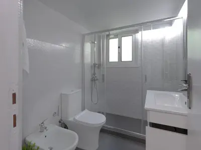 a bathroom with a toilet and a shower and a sink at Stylish Sanctuary, Pangrati Gem Refurbished in Athens