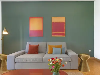 a living room with a gray couch with colorful pillows at Stylish Sanctuary, Pangrati Gem Refurbished in Athens