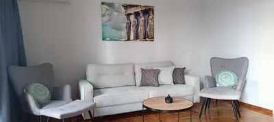 a living room with a couch and two chairs at Caryatids Luxury Apartment in Athens