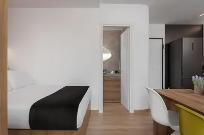 a bedroom with a bed and a dining table at Athenian Riviera Seaside Suite in Athens