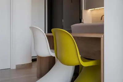 two yellow and white chairs sitting next to a bed at Athenian Riviera Seaside Suite in Athens