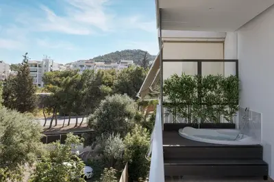 a bathroom with a tub on the balcony of a building at Athenian Riviera Seaside Suite in Athens