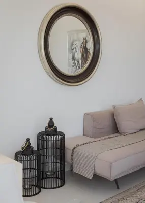 a living room with a couch and a mirror at Athenian Riviera Penthouse Apartment in Varkiza