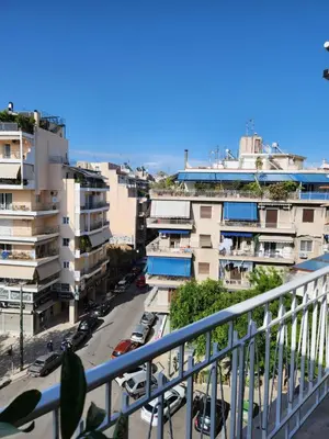 a view from a balcony of a city with buildings at Bachelor Penthouse with Roof Garden access, 15 m walk to Acropolis in Athens