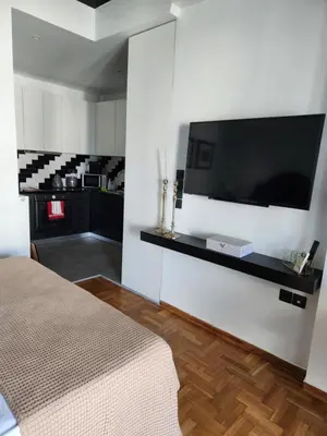 a bedroom with a flat screen tv on a wall at Bachelor Penthouse with Roof Garden access, 15 m walk to Acropolis in Athens