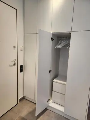 a white closet with white cabinets and a door at Bachelor Penthouse with Roof Garden access, 15 m walk to Acropolis in Athens