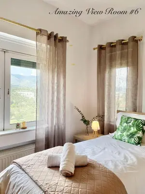 a bedroom with a bed and a window with a view at Villa Zen Kyriakos Magnificent Vibes in Paianía