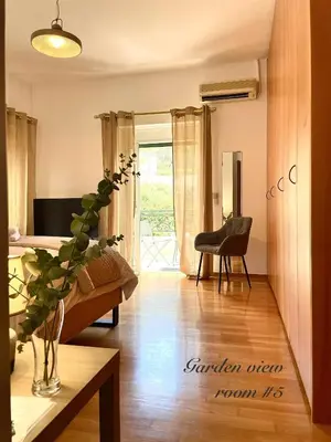 a living room with a couch and a table at Villa Zen Kyriakos Magnificent Vibes in Paianía