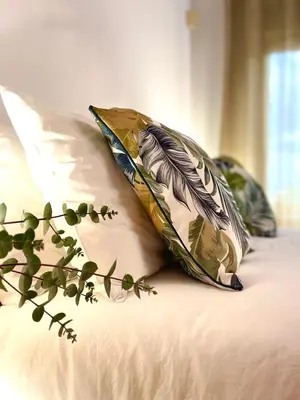 a bed with two pillows and a feather pillow on it at Villa Zen Kyriakos Magnificent Vibes in Paianía