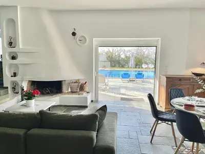 a living room with a couch and a fireplace at Villa Zen Kyriakos Magnificent Vibes in Paianía