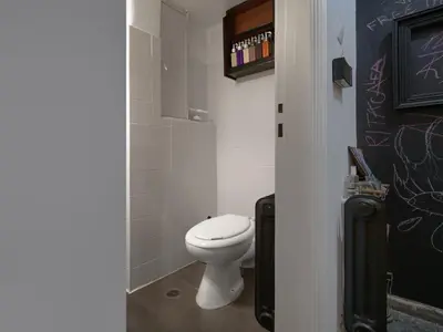 a bathroom with a toilet with graffiti on the wall at Central Apartment in Pangrati - Opp Pangrati Grove in Athens