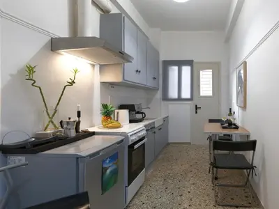 a kitchen with a sink and a stove top oven at Central Apartment in Pangrati - Opp Pangrati Grove in Athens