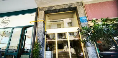 a store front with a window with a balcony at Central Apartment in Pangrati - Opp Pangrati Grove in Athens