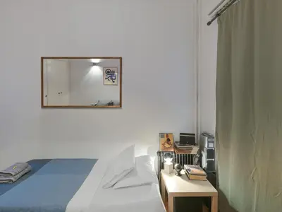 a bedroom with a bed and a mirror on the wall at Central Apartment in Pangrati - Opp Pangrati Grove in Athens