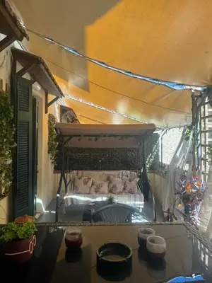 an outdoor patio with a bed with a canopy at ATHENS CITY THEMIS 4 in Athens