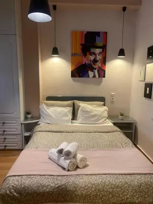 a bedroom with a bed with two towels on it at ATHENS CITY THEMIS 4 in Athens