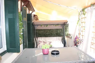 a balcony with a table and a potted plant at ATHENS CITY THEMIS 4 in Athens