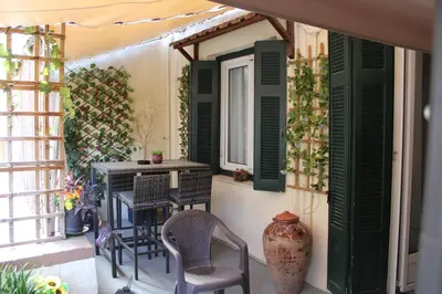 a balcony with a table and chairs and a window at ATHENS CITY THEMIS 4 in Athens
