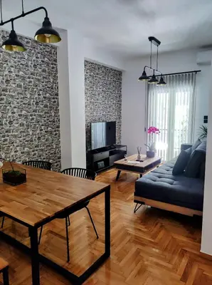 a living room with a couch and a table at Where Dreams Attend Address! in Athens