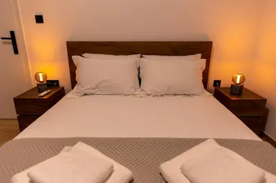 a bedroom with a bed with two towels on it at Where Dreams Attend Address! in Athens