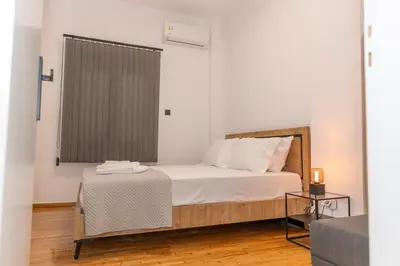 a small bedroom with a bed and a table at Where Dreams Attend Address! in Athens
