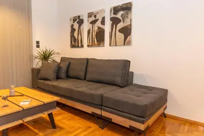 a couch in a living room with a table at Where Dreams Attend Address! in Athens