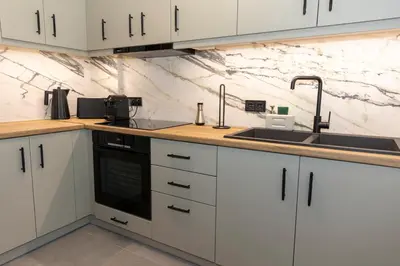 a kitchen with white cabinets and a sink at Where Dreams Attend Address! in Athens