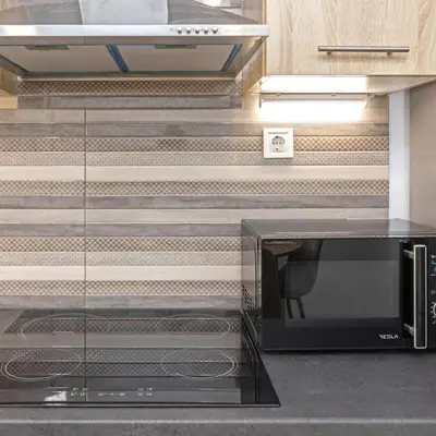 a microwave sitting on a counter in a kitchen at Cozy Apartment in Kallithea in Athens