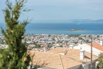 a view of a city with the ocean in the background at Luxury Home with Jacuzzi and Spectacular Sea Views for 8 Guests in Athens