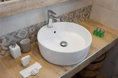 a white sink on a counter in a bathroom at Varkiza Seaside Apartment in Vari