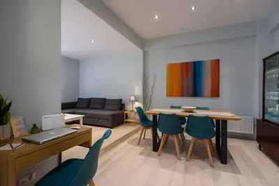 a living room with a table and chairs and a couch at Elektra Suite in Athens
