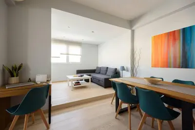 a living room with a table and chairs and a couch at Elektra Suite in Athens