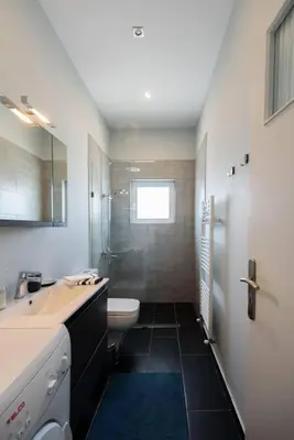 a white bathroom with a sink and a toilet at Elektra Suite in Athens