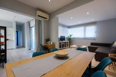 a living room with a wooden table and a couch at Elektra Suite in Athens